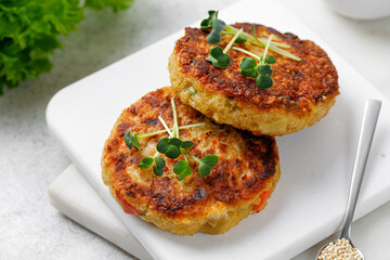 Vegan cutlets made with quinoa and vegetables, served with microgreens. Delicious vegan food....