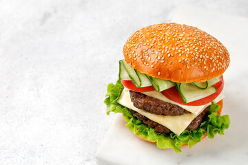 Delicious Beef Burger with Cheese, cutlets, cucumber, lettuce on white background. Fast Food Restaurant menu