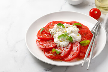 Italian caprese salad with stracciatella, tomatoes and basil. Copy space