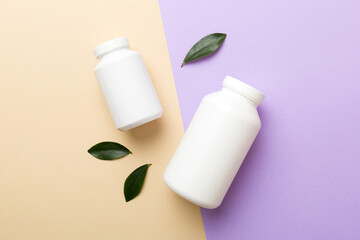 supplement pills with medicine bottle health care and medical top view. Vitamin tablets. Top view mockup bottle for pills and vitamins with green leaves, natural organic bio supplement, copy space
