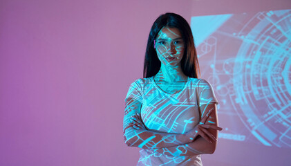 Abstract picture. Beautiful young woman is in projector neon lights in the studio