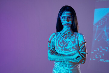 Abstract picture. Beautiful young woman is in projector neon lights in the studio