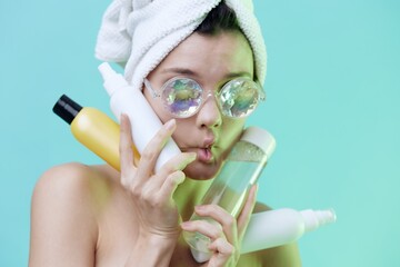  Horizontal photo, a woman with sparse skin on a blue background in a towel in beautiful glasses...