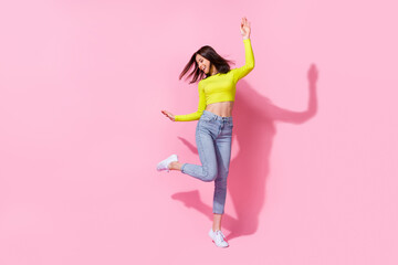 Full size portrait of overjoyed cheerful girl have fun good mood dance clubbing isolated on pink...
