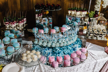 Table with muffins, cakes, sweets, candy, buffet. Dessert table for a party goodies for the wedding banquet area. Close up. candy bar. Decorated delicious.