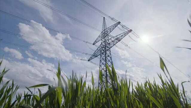 time lapse of clouds passing over high voltage power line in sunlight