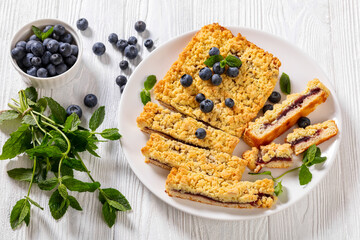 sliced blueberry crumble pie on plate, top view