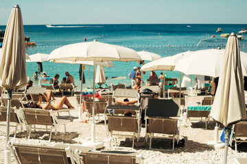 Unfocused beach chairs and umbrellas on the beach of Croatia islands on Adriatic sea