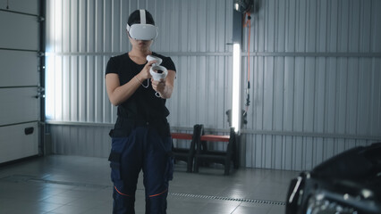 Asian woman car service worker in virtual reality headset with controllers and in uniform standing...
