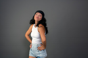 young woman with bandana making funny gesture