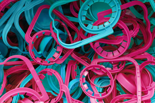 The concept of caring for the environment. Many different plastic bottle caps for recycling. Screw caps rings rubbish. Eco friendly theme - care about the Earth. Avoid pollution © Lavsketch