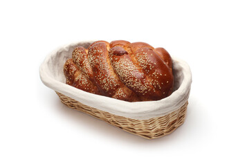 Challah baked bread in straw basket on white background.