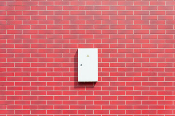 Grey Hinged Power electrical Box on the red Wall.Copy space.