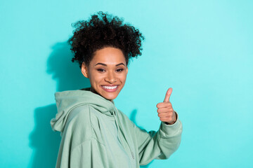 Profile portrait of attractive positive girl hand finger demonstrate thumb up isolated on teal color background