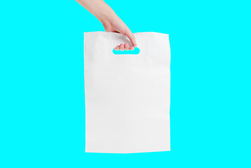 White plastic shopping bag in hand