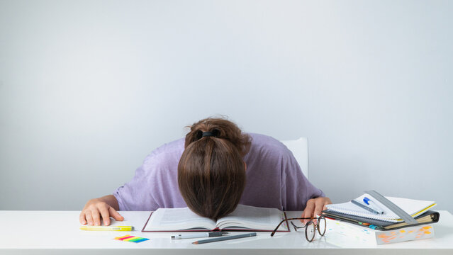 A Student Sleeps On A Textbook - Difficult Study, Heavy Load