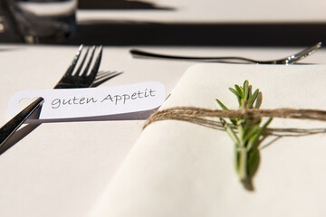 Elegant german table decoration with fork, rosemary and the words 