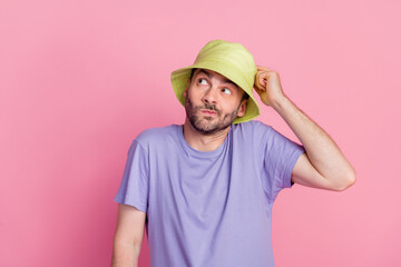 Portrait of funny clueless guy boy wear stylish clothes shrugging shoulder arm touch cap dont know answer isolated on pink color background