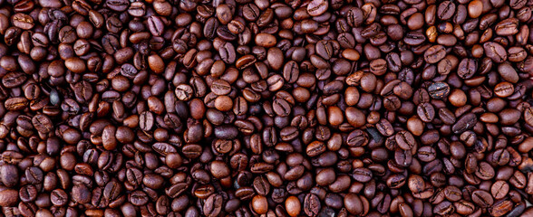 Freshly roasted coffee beans background. Coffee beans background. Background of roasted coffee beans.