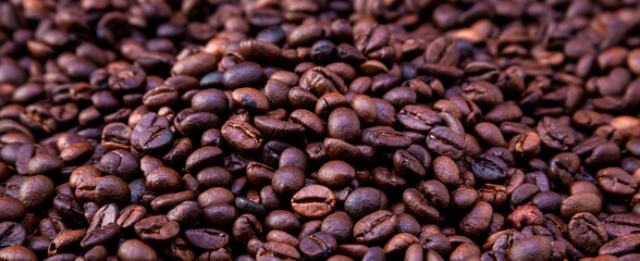 Freshly roasted coffee beans background. Coffee beans background. Background of roasted coffee beans.