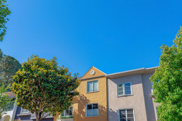 Facade of adjacent houses with painted stucco walls at San Francisco, CA