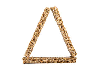 Triangle of strips of kozinak from seeds and molasses on a white background.