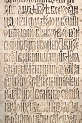 Ancient cyrillic symbols old church slavonic words on a stone plate - obrazy, fototapety, plakaty
