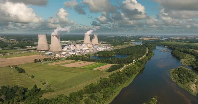 Aerial panoramic flight of around the nuclear power plant. Carbon dioxide emissions, energy of smoke and steam. Ecology and pollution of nature.