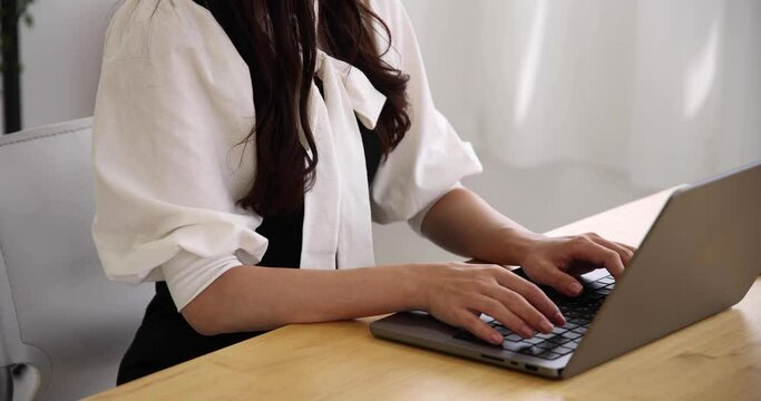 A Japanese woman checking smartphone in the home office faceless composition