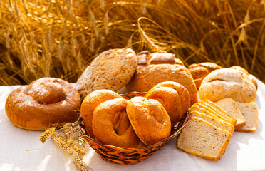 lot of different flavored bread, wheat, rye, on the table in the field outside