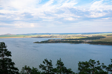 The landscape of the lake, and a distant view of the shore.