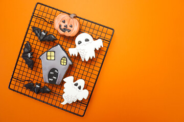 Gingerbread cookies for Halloween celebration are on an orange background