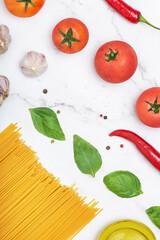 culinary background with pasta and vegetables. Food preparation. Ingredients for pasta. Vertical