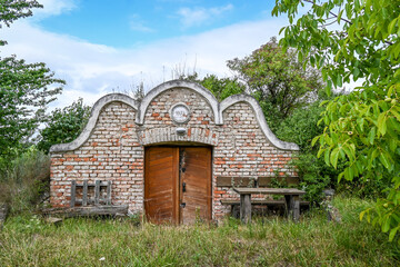 A beautiful old wine cellar on the edge of a field.