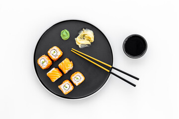 Salmon sushi rolls set on plate, top view. Japanese cuisine