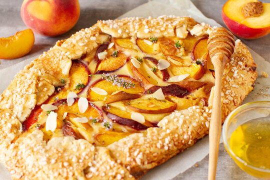 Homemade rustic style peach french galette on a table. Summer homemade sweet pastries - Powered by Adobe