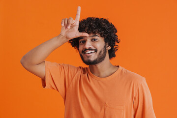Young indian handsome curly smiling man showing L gesture