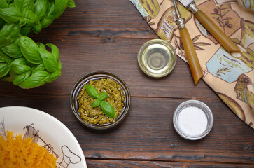 ingredients for cooking dinner pasta with pesto sauce on the table