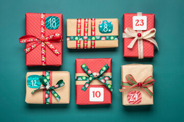 Xmas advent calendar concept Handmade wrapped red, green gift boxes decorated with ribbons,...