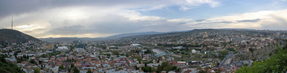 A panoramic aerial view of Tbilisi from Sololaki hill on a cloudy evening
