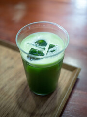 ice green tea matcha with milk on wooden table in cafe