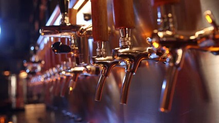 The beer taps in a pub. nobody. Selective focus. Alcohol concept. Vintage style. Beer craft. Bar table. Steel taps. Shiny taps.