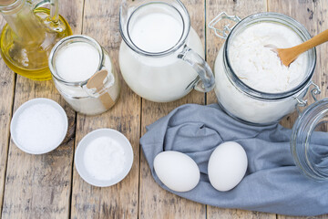 ingredients for making dough on a wooden table for pancakes in nature