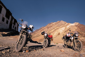 group of off-road motorcycles without people standing at sunset against stunning beautiful colored mountain landscape