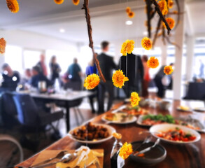 Easter celebration at a restaurant with yellow flower decorations hanging above the food buffet