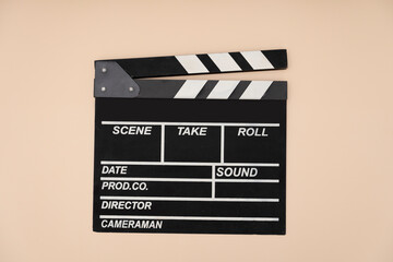 Fototapeta na wymiar movie clapper on yellow table background ; film, cinema and video photography concept