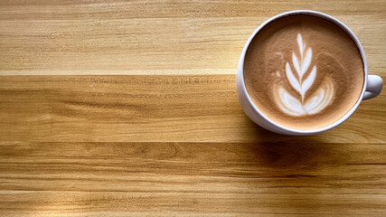 breakfast with hot cup of coffee latte at a cafe background brown wooden table close up top view