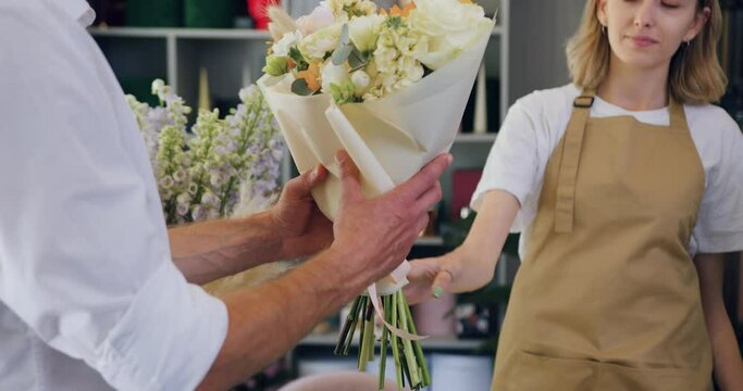 Close up of man buying bouquet of flowers. Shopping concept.