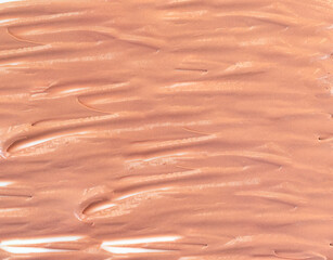 Swatch of foundation tone cream texture background