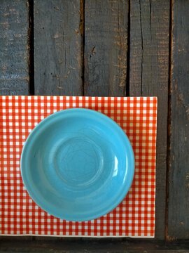 plate and cutlery on wood background 